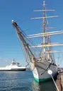 Tall ship alongside with ferry in backgroung