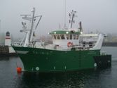 Green fishing vessel in port