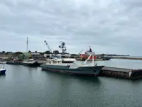 Grey Yacht alongside